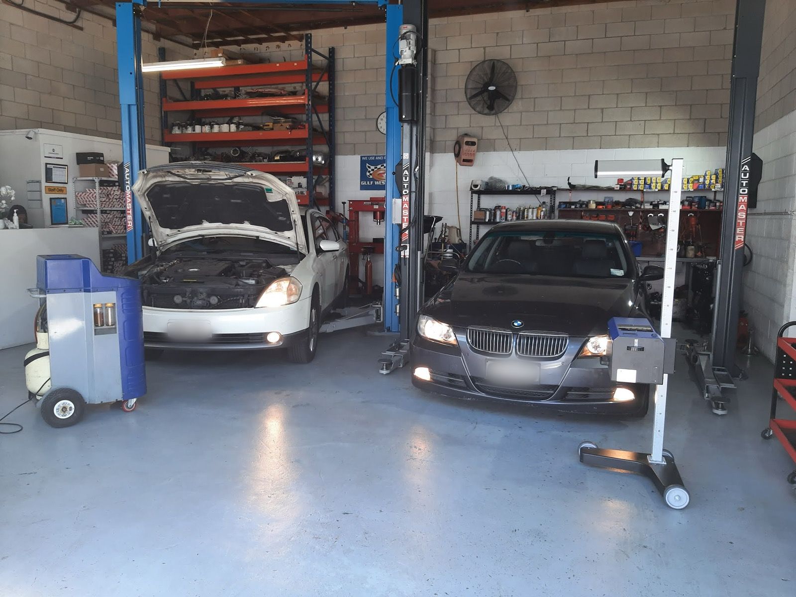 Vehicle on a hoist with headlight testing equipment ready for a WOF inspection